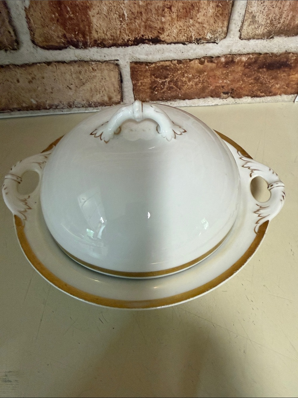 A Haviland & Co. Limoges porcelain covered tureen with gold trim. Butter Dish.